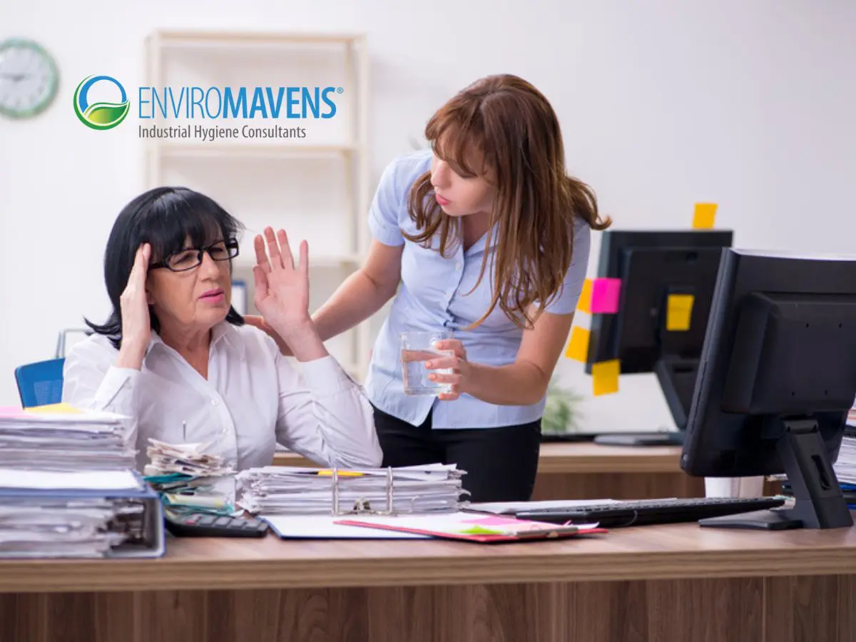 Two women in a busy office