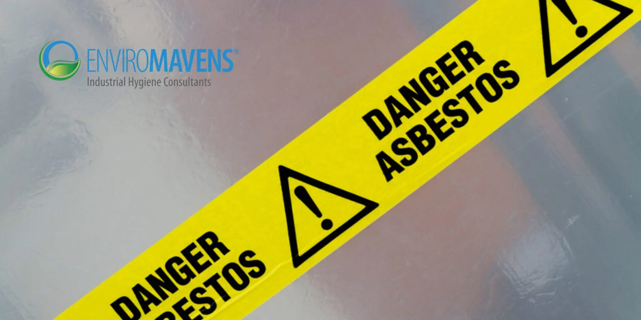 Asbestos danger tape on reflective surface.