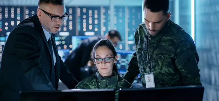 Military personnel collaborating in control room