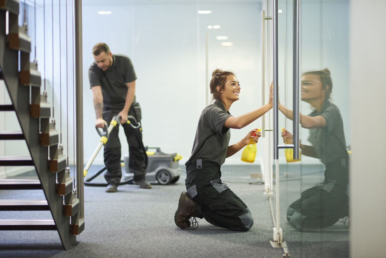Commercial cleaning contractors cleaning the inside of an office; industrial hygiene concept