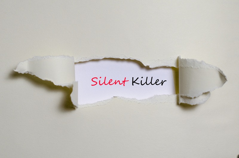 A torn piece of paper displaying the word "silent killer"