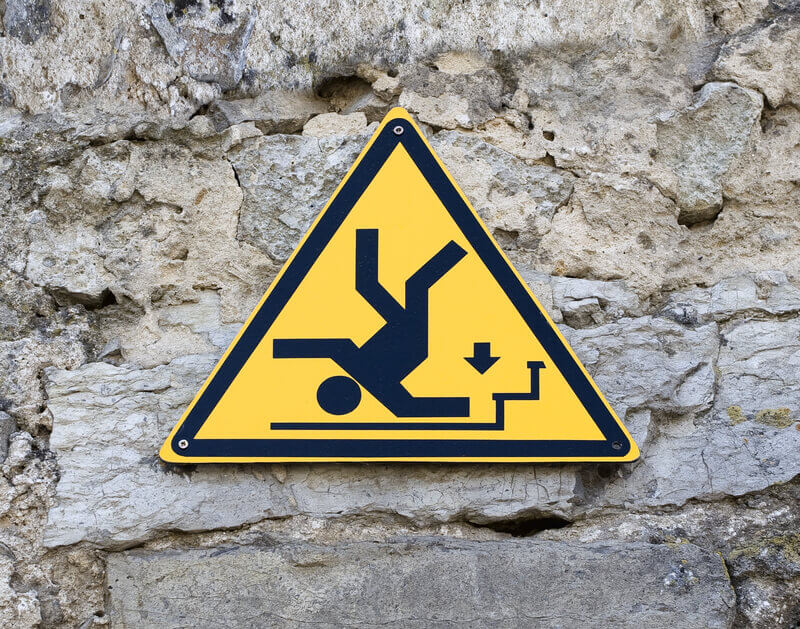 Caution sign with man falling on steps