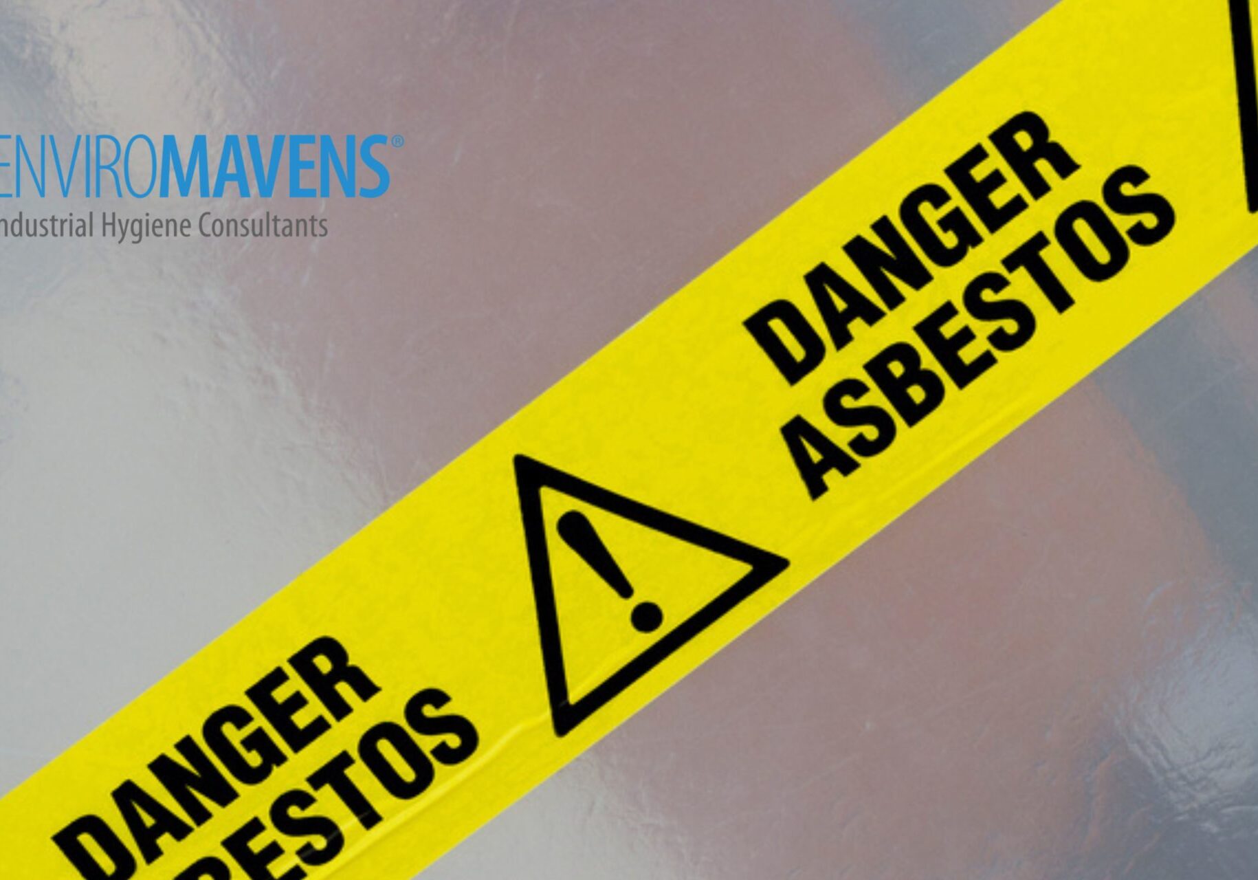 Asbestos danger tape on reflective surface.