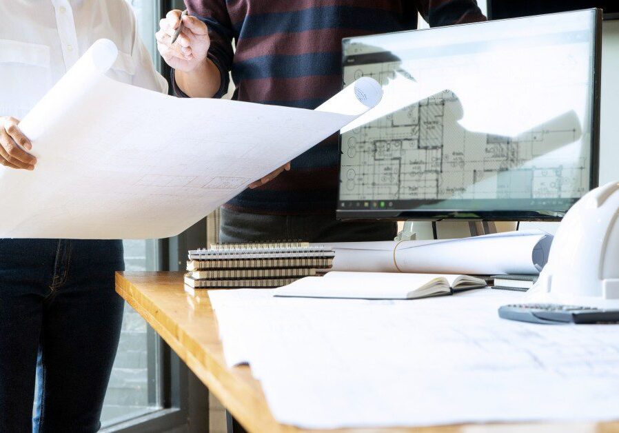 Office workspace with construction drawings