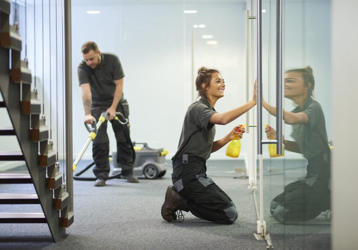 Cleaning crew maintaining office cleanliness